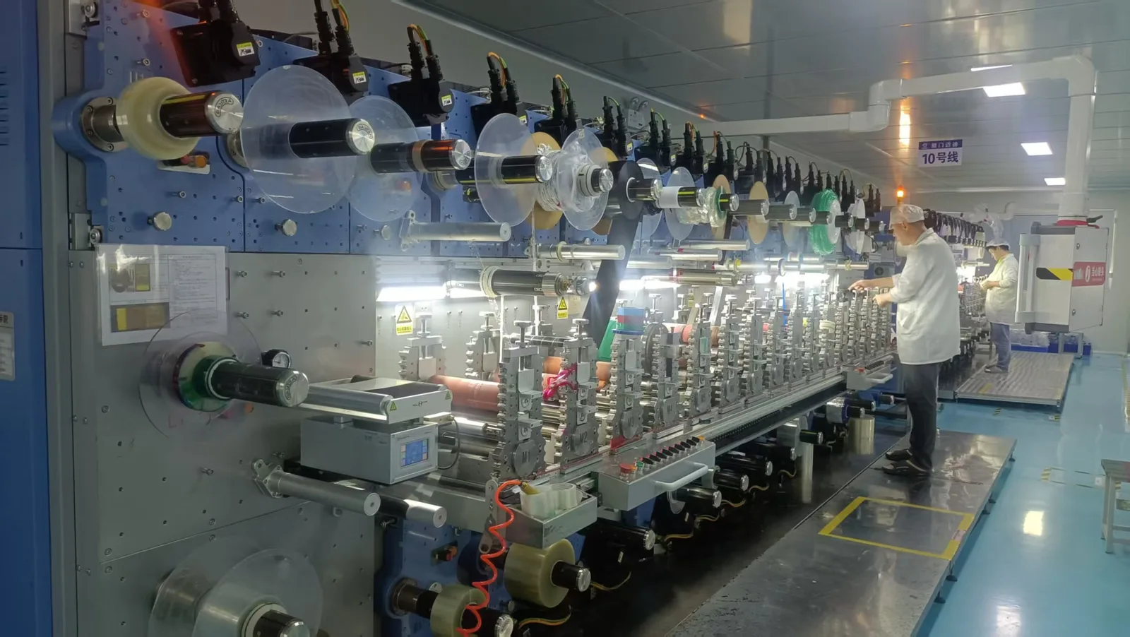 Multi-station rotary die-cutting line operating inside the cleanroom workshop